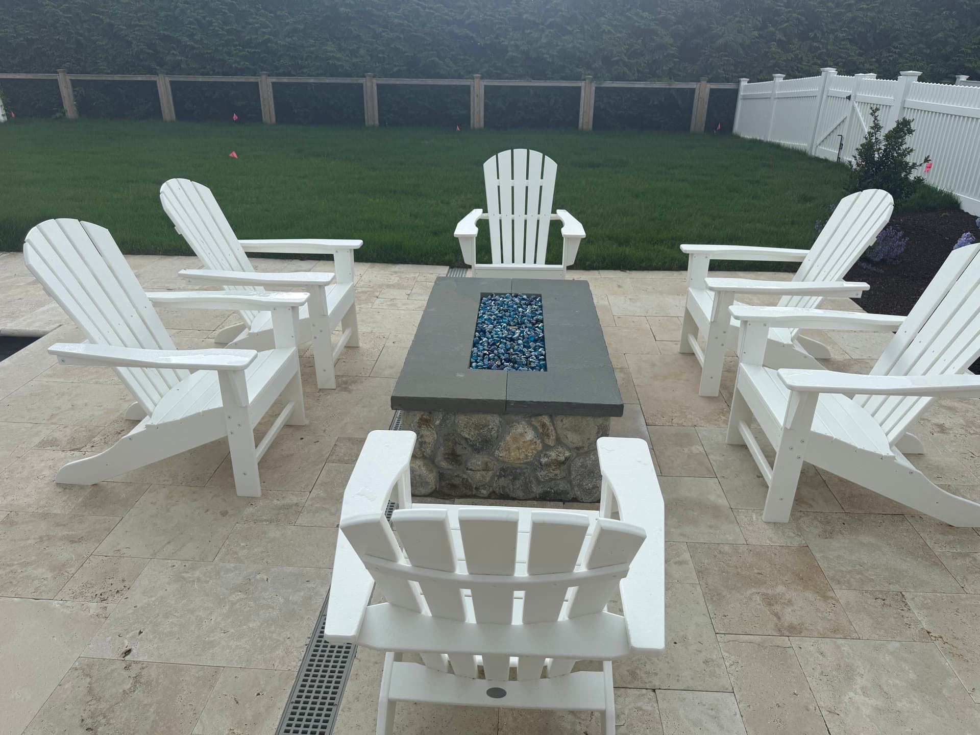 Poolside Fire Pit Built with Round Fieldstone and Bluestone Cap image
